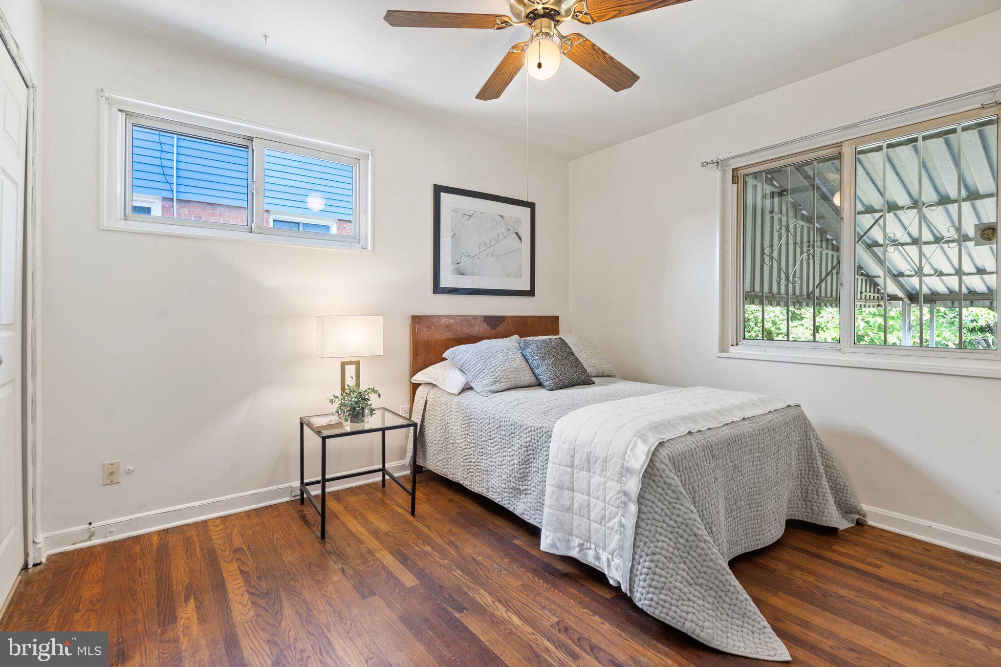 4618 Hilltop Terrace Southeast Washington, DC 20019 - Photo 16 of 36 a bedroom with a bed and wooden floor