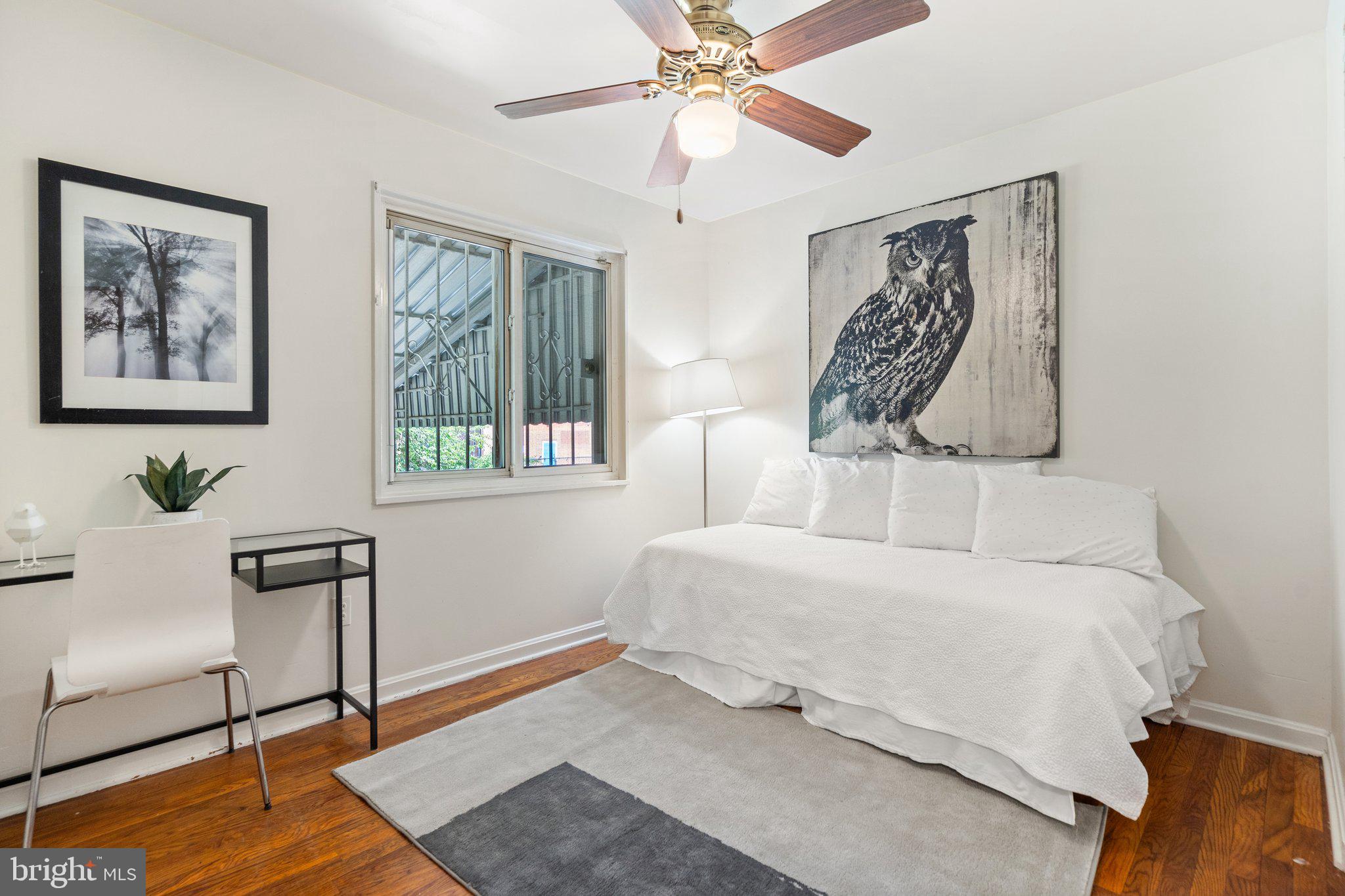4618 Hilltop Terrace Southeast Washington, DC 20019 - Photo 18 of 36 a bedroom with a bed and a painting on the wall