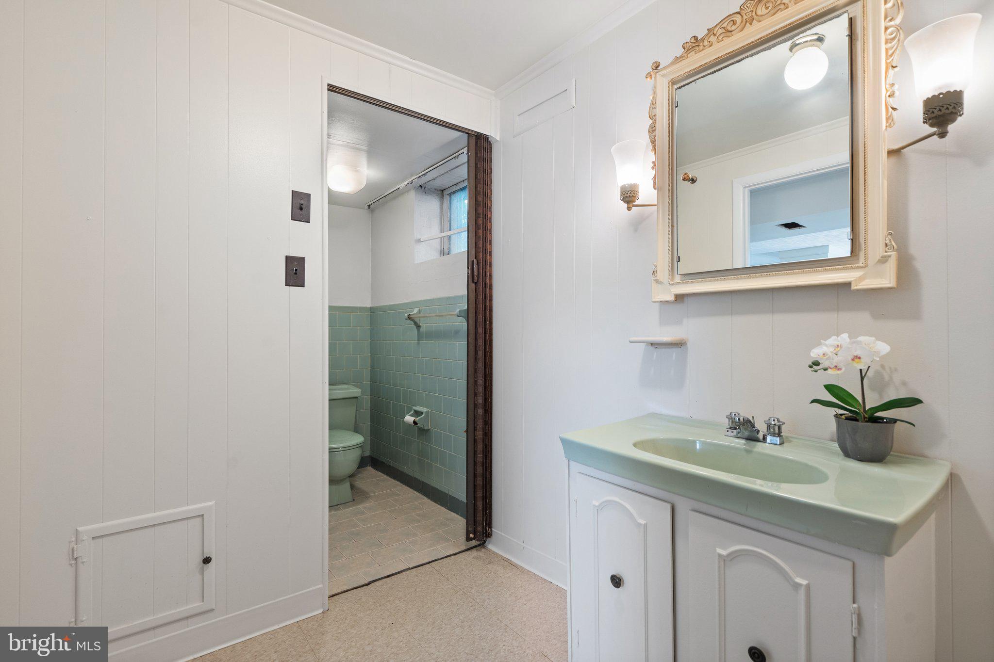 4618 Hilltop Terrace Southeast Washington, DC 20019 - Photo 25 of 36 a bathroom with a granite countertop sink a mirror and vanity