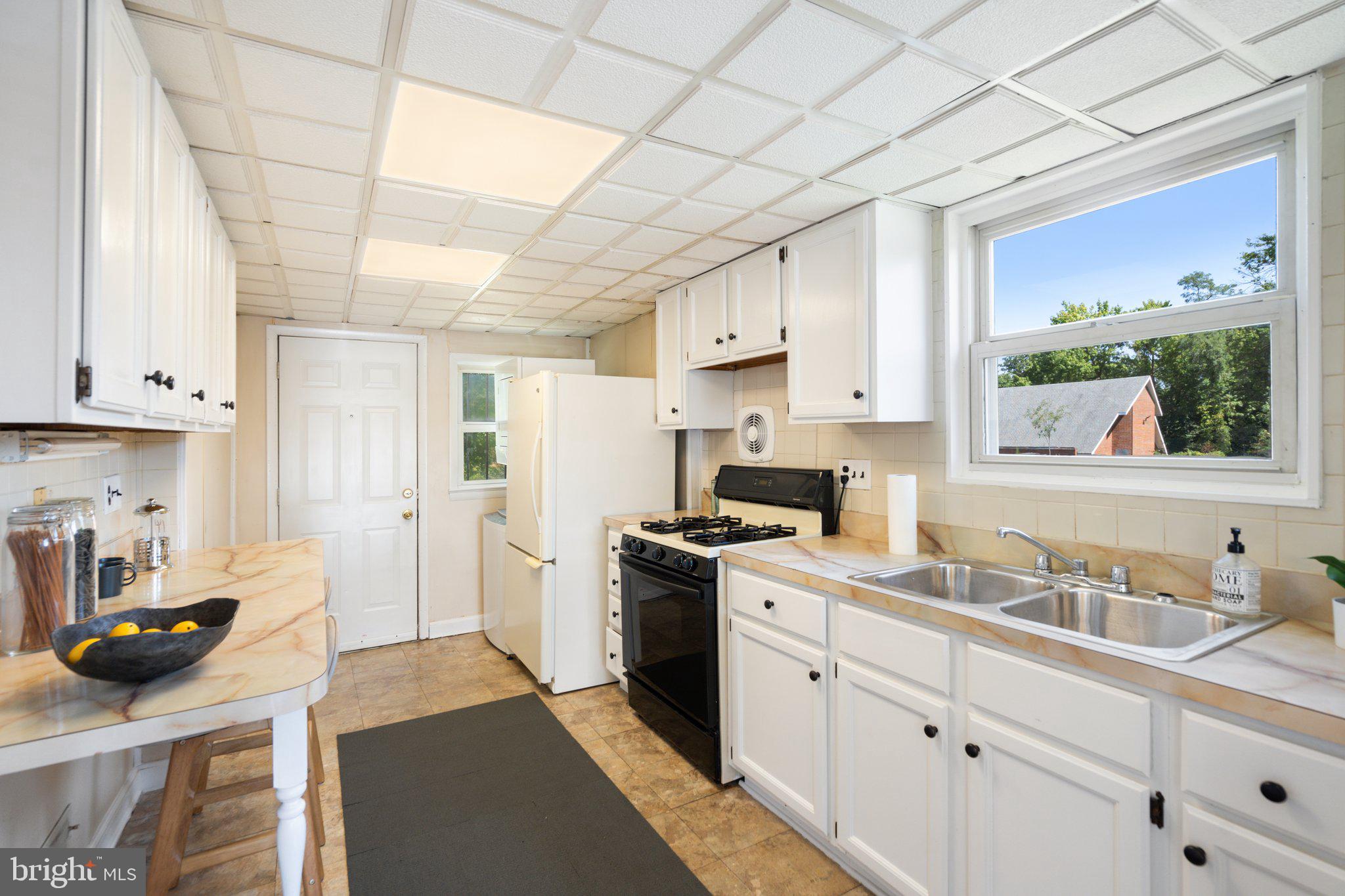 4618 Hilltop Terrace Southeast Washington, DC 20019 - Photo 10 of 36 a kitchen with stainless steel appliances granite countertop a sink stove and refrigerator