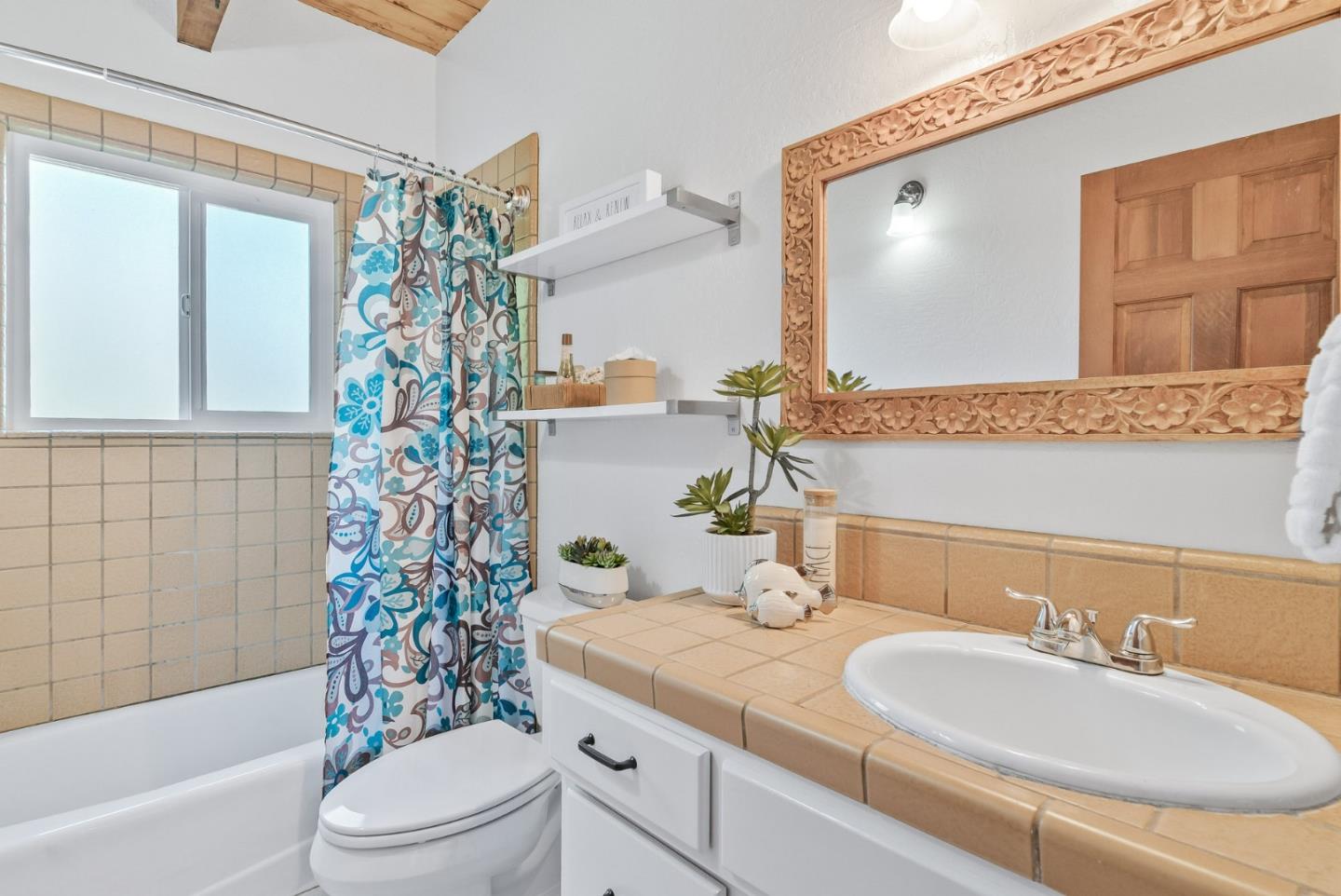 620 Sumner Street Santa Cruz, CA 95062 - Photo 18 of 45 a bathroom with a granite countertop sink toilet a mirror a vanity and shower