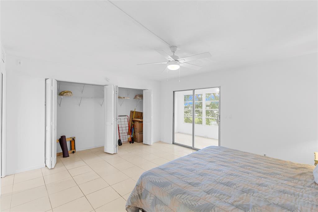 4047 Cambridge C, Unit 4047 Deerfield Beach, FL 33442 - Photo 15 of 43 a bedroom with a bed and a window