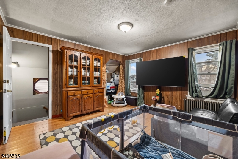 150 Jefferson Street Paterson, NJ 07522 - Photo 13 of 31 a living room with furniture and a flat screen tv