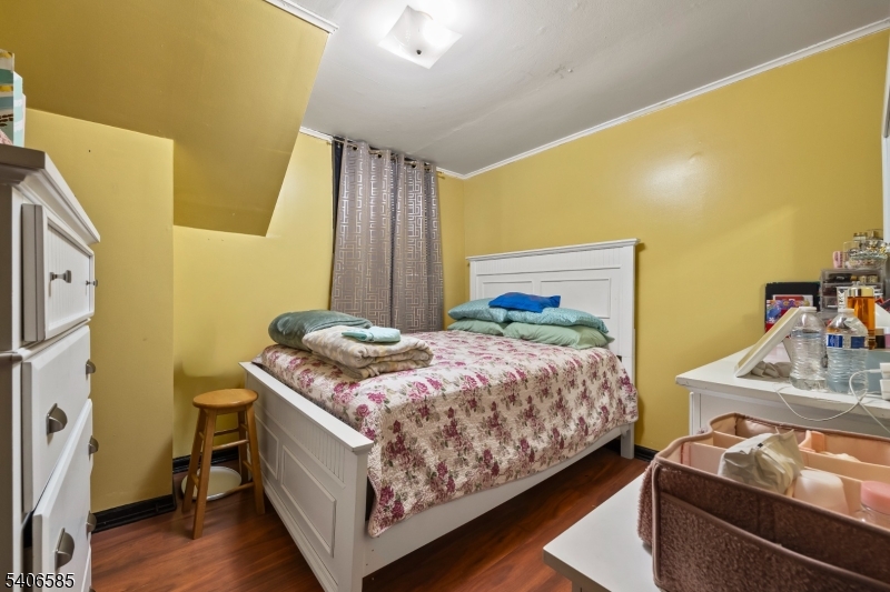 150 Jefferson Street Paterson, NJ 07522 - Photo 15 of 31 a bedroom with a bed and wooden floor