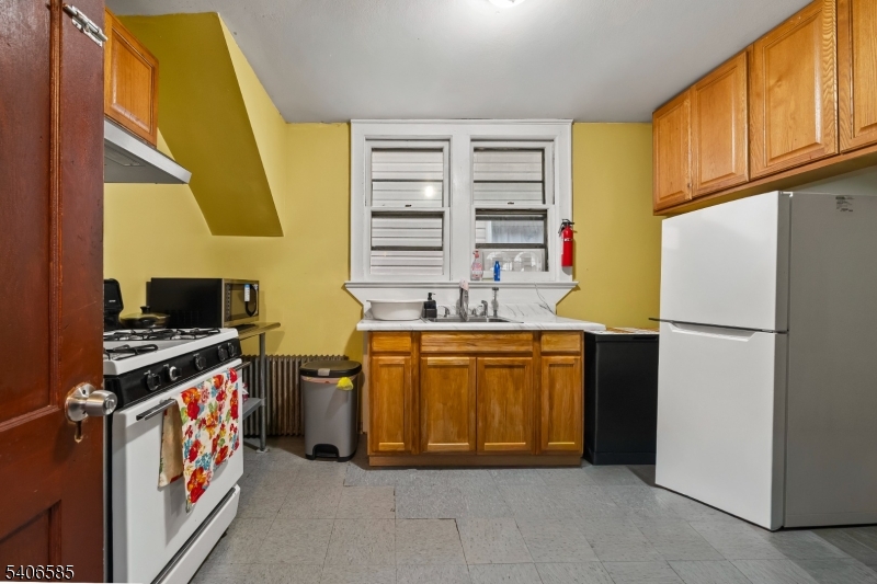150 Jefferson Street Paterson, NJ 07522 - Photo 17 of 31 a kitchen with stainless steel appliances granite countertop a stove and a refrigerator