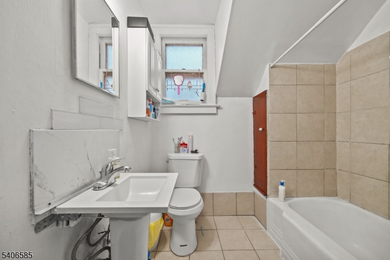 150 Jefferson Street Paterson, NJ 07522 - Photo 18 of 31 a bathroom with a sink toilet and shower