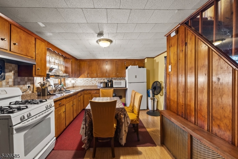150 Jefferson Street Paterson, NJ 07522 - Photo 8 of 31 a kitchen with stainless steel appliances granite countertop a sink a stove and cabinets