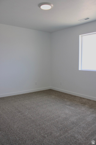 2613 Scarlet Road, Unit 258 Eagle Mountain, UT 84005 - Photo 23 of 32 Carpeted room with white walls, white baseboards, a single window, and a flush-mount ceiling light