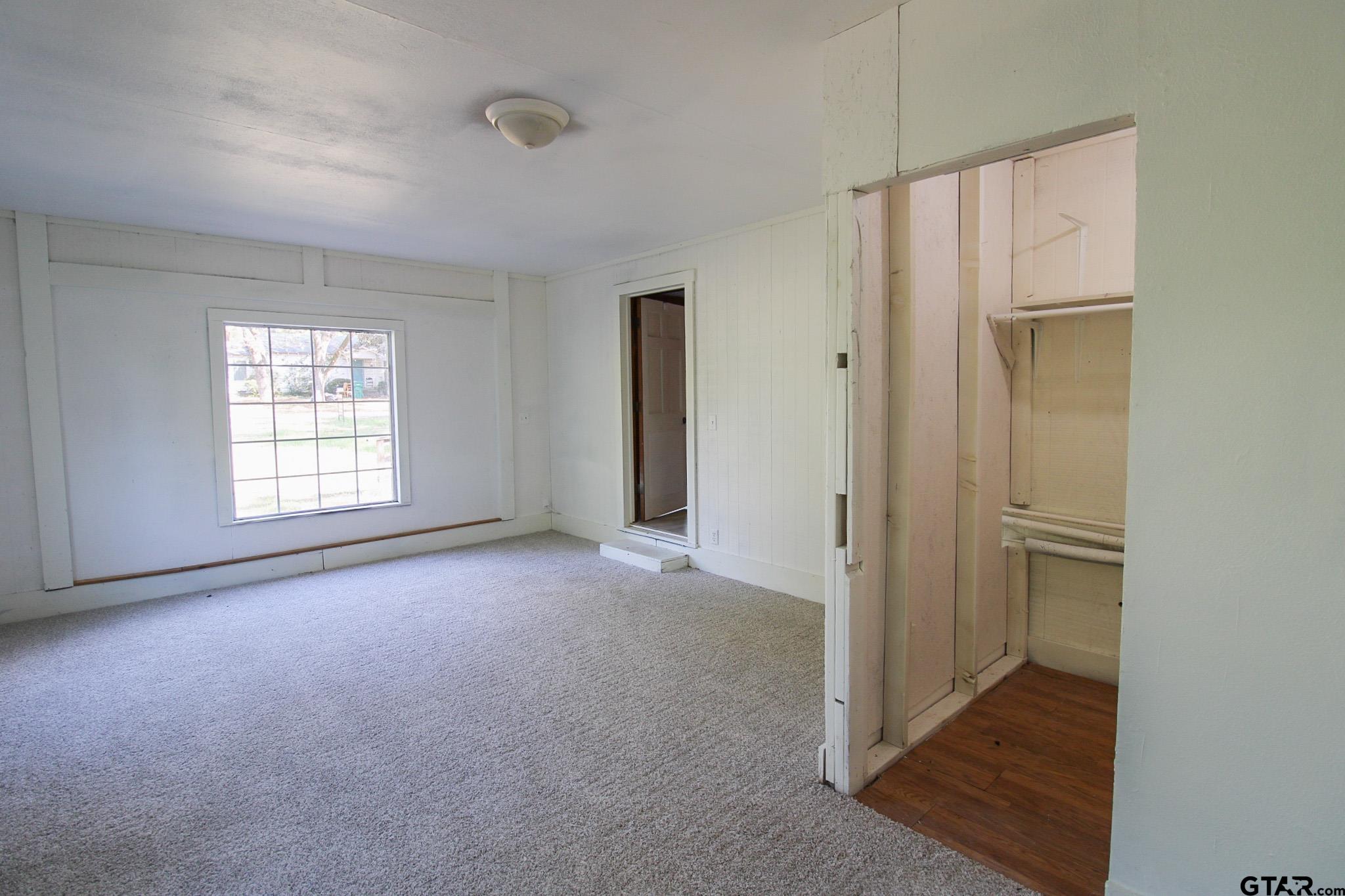 407 Pace Street Naples, TX 75568 - Photo 14 of 31 an empty room with windows and closet