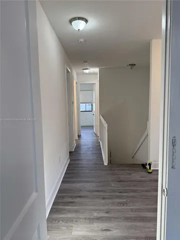 a bathroom with a granite countertop toilet a sink and a mirror