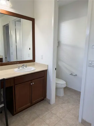 a view of bathroom with mirror and door