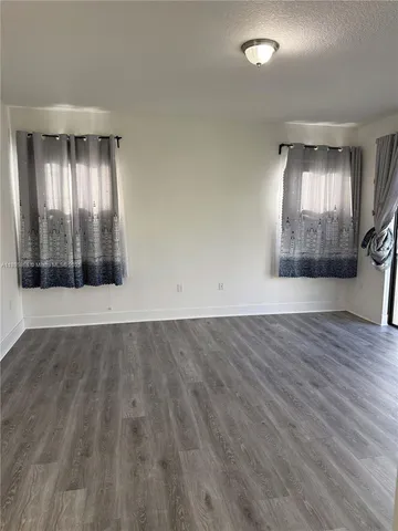 a view of a room with wooden floors and led lights