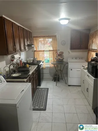 a kitchen with a sink a stove a refrigerator and cabinets