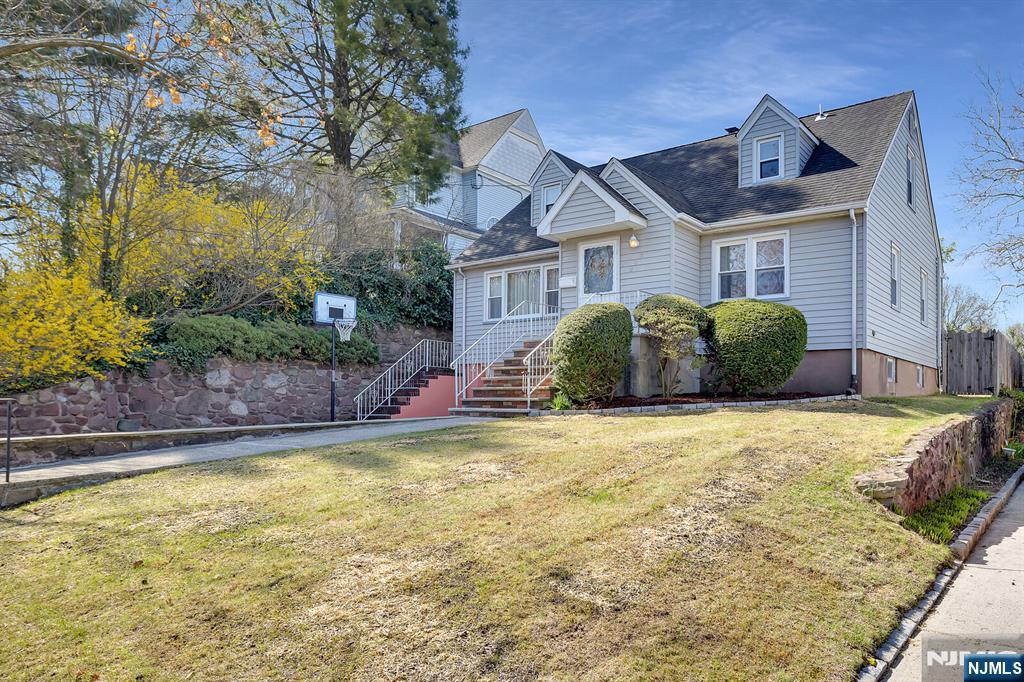 243 Donaldson Avenue Rutherford, NJ 07070 - Photo 35 of 36 a front view of a house with a garden