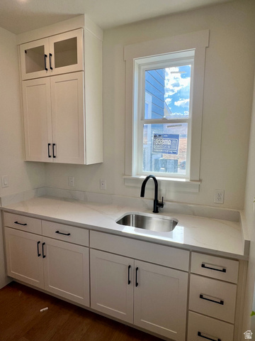 11507 Markfield Way, Unit 1124 South Jordan, UT 84009 - Photo 4 of 6 White shaker cabinetry with matte black hardware, quartz countertops, undermount stainless steel sink, and a black gooseneck faucet