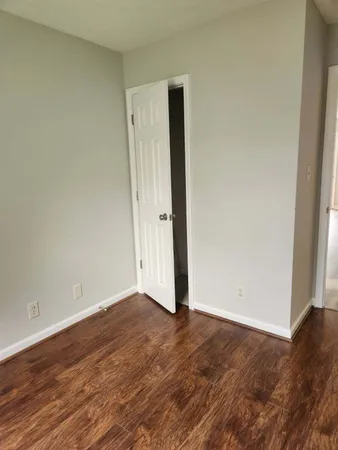 an empty room with wooden floor