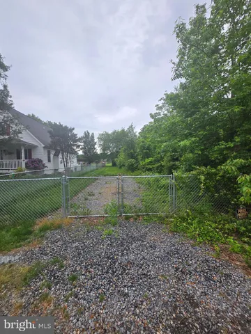 a view of outdoor space with green field and trees