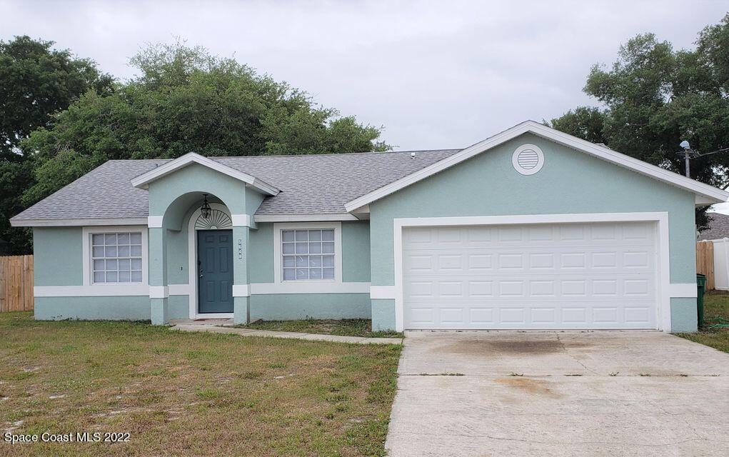5649 Beaverbrook Street Cocoa, FL 32927 - Photo 1 of 29 a front view of a house with a yard and garage
