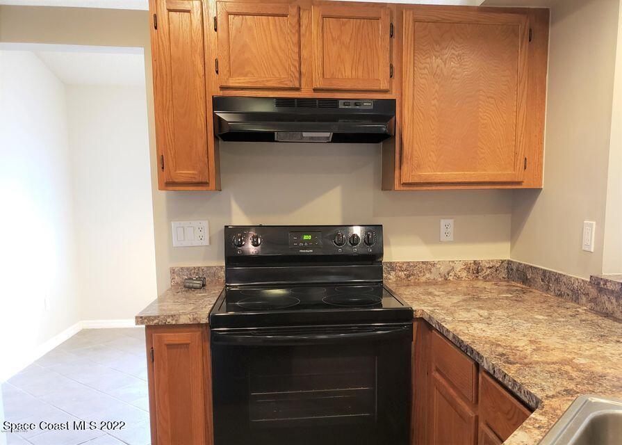5649 Beaverbrook Street Cocoa, FL 32927 - Photo 12 of 29 a stove top oven sitting inside of a kitchen
