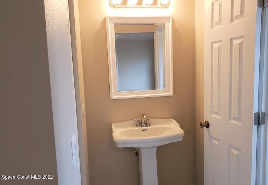 5649 Beaverbrook Street Cocoa, FL 32927 - Photo 17 of 29 a bathroom with a sink and mirror