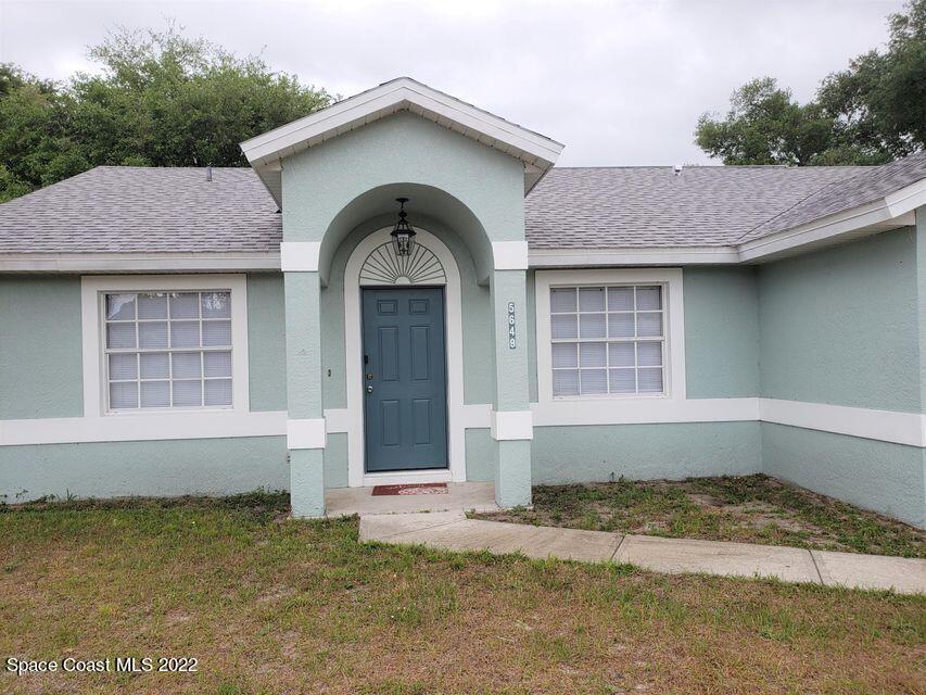 5649 Beaverbrook Street Cocoa, FL 32927 - Photo 3 of 29 a front view of a house with a yard