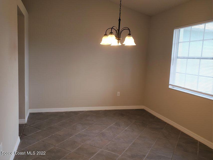 5649 Beaverbrook Street Cocoa, FL 32927 - Photo 5 of 29 a view of big room with windows and chandelier