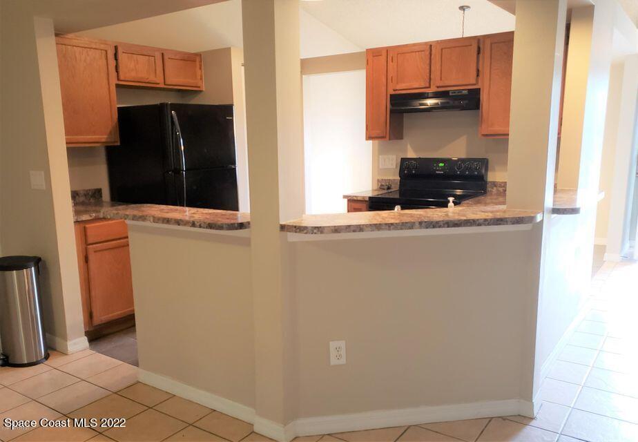 5649 Beaverbrook Street Cocoa, FL 32927 - Photo 6 of 29 a kitchen with a refrigerator and a stove