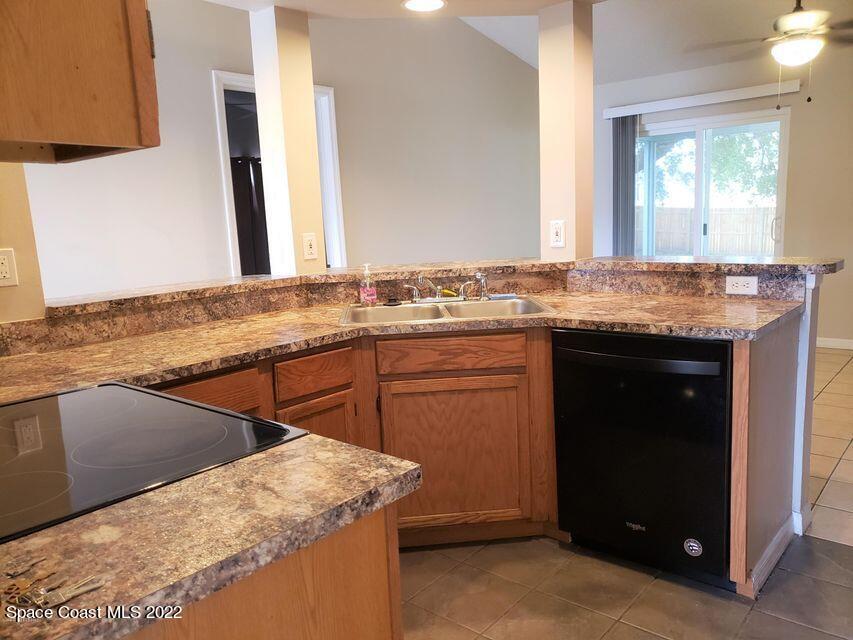 5649 Beaverbrook Street Cocoa, FL 32927 - Photo 7 of 29 a kitchen with a sink stove and mirror
