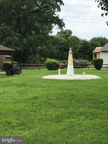 a view of house with backyard