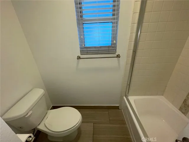 a bathroom with a toilet and bathtub
