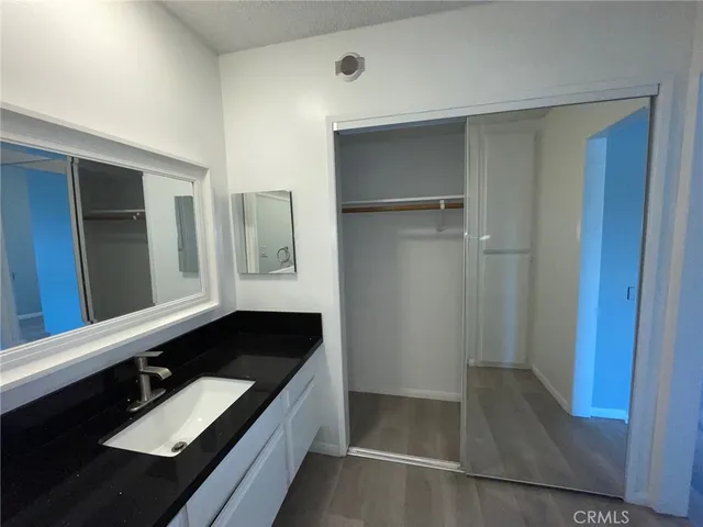 a bathroom with a double vanity sink and a mirror