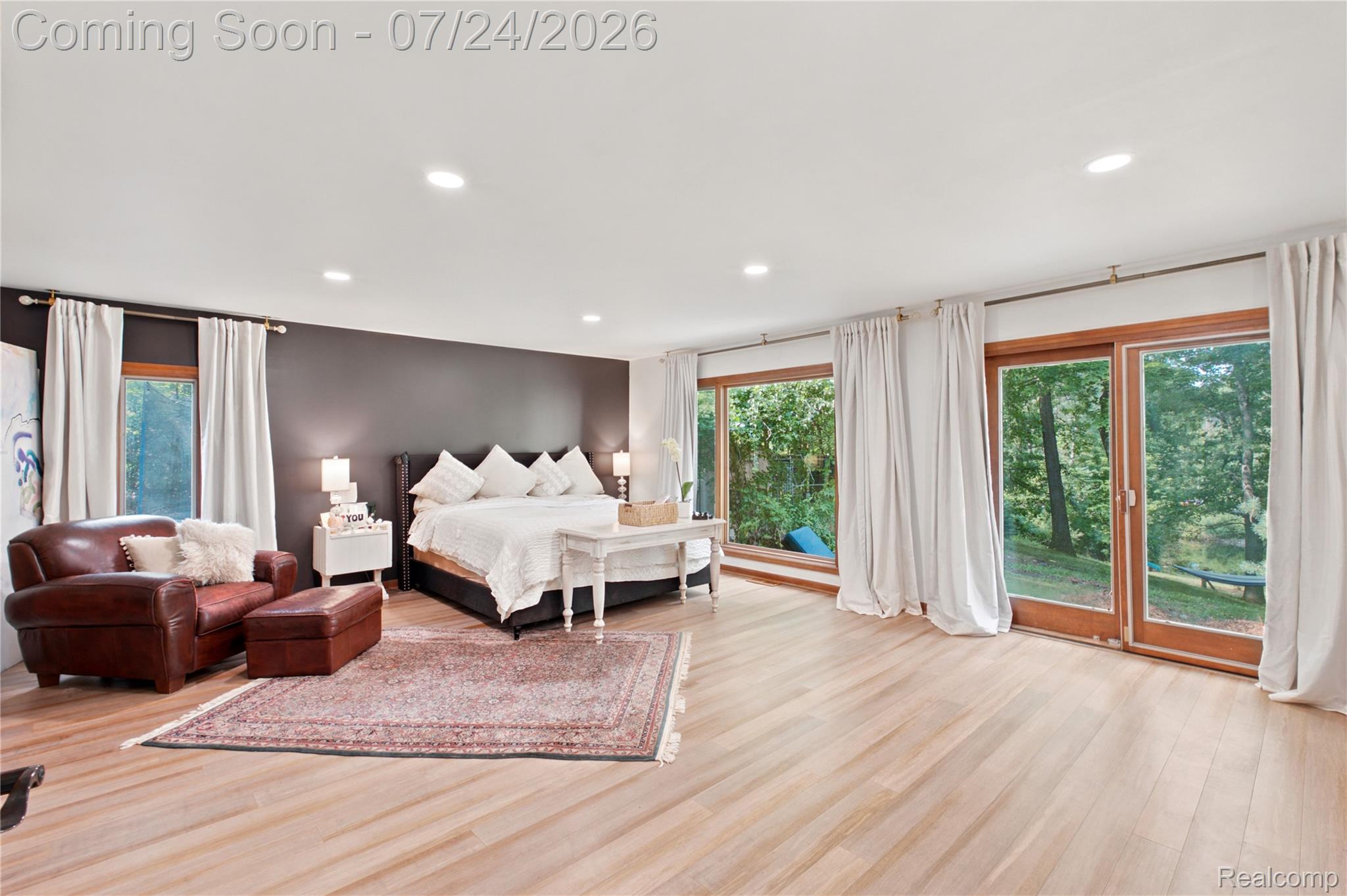 377 Ridgemont Road Oxford, MI 48370 - Photo 28 of 52 Spacious room featuring light wood-finish flooring, recessed lighting, and expansive floor-to-ceiling sliding glass doors with wood frames