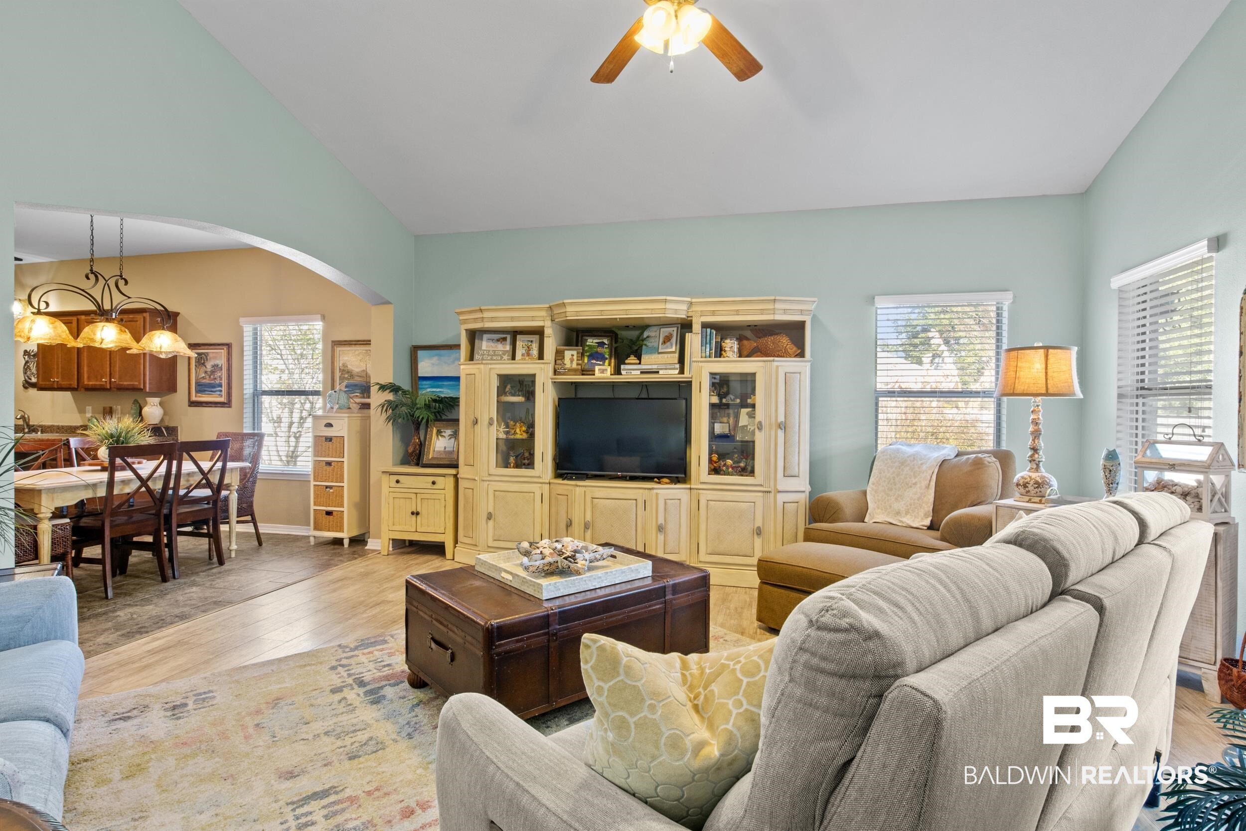 1752 Abbey Loop Foley, AL 36535 - Photo 3 of 21 Living room featuring a wealth of natural light, ceiling fan with notable chandelier, light hardwood / wood-style floors, and vaulted ceiling