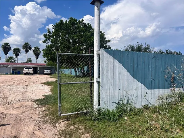 a view of a garden with a wooden fence