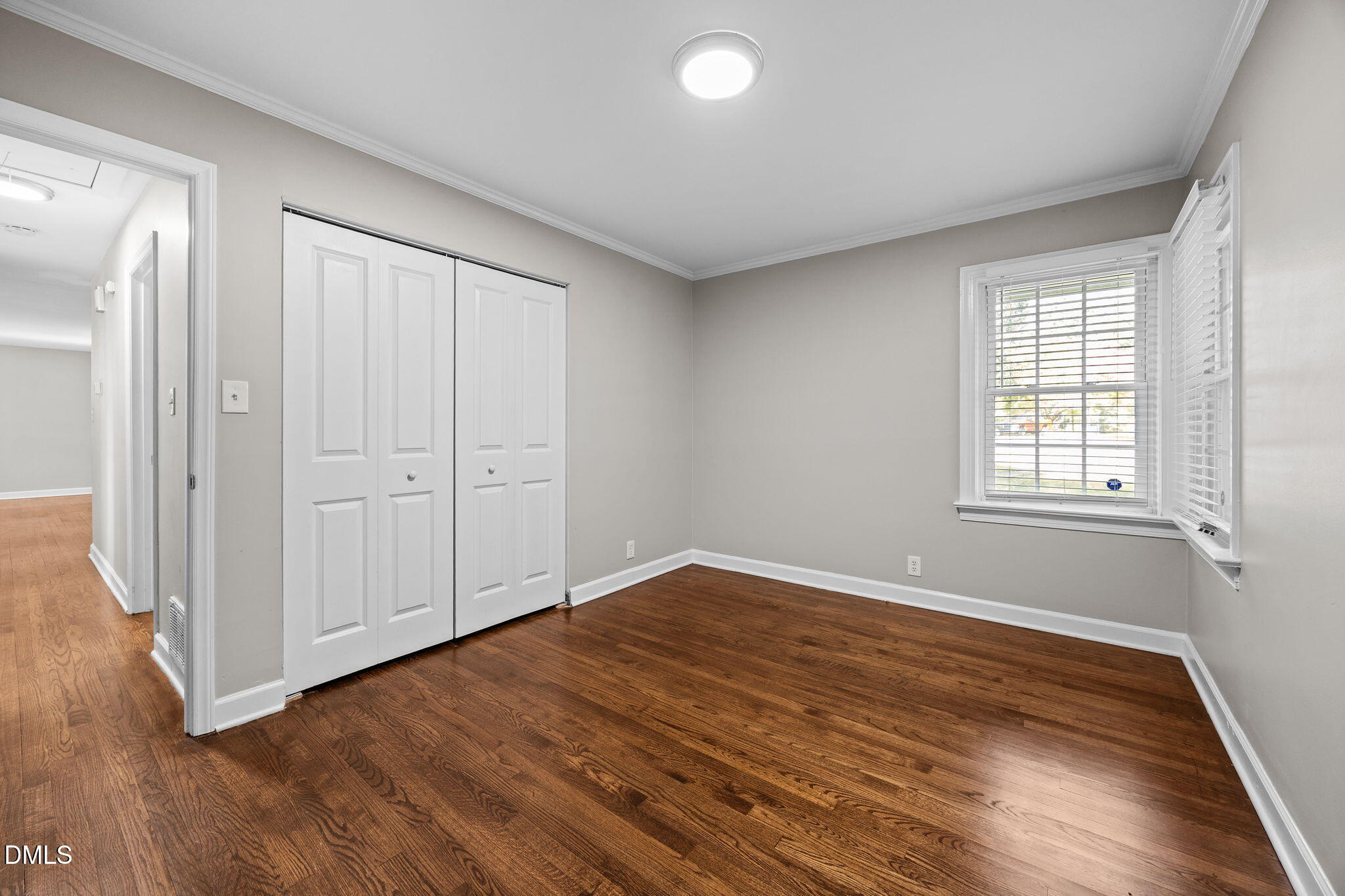 2950 Glenridge Drive Raleigh, NC 27604 - Photo 36 of 53 an empty room with wooden floor and windows