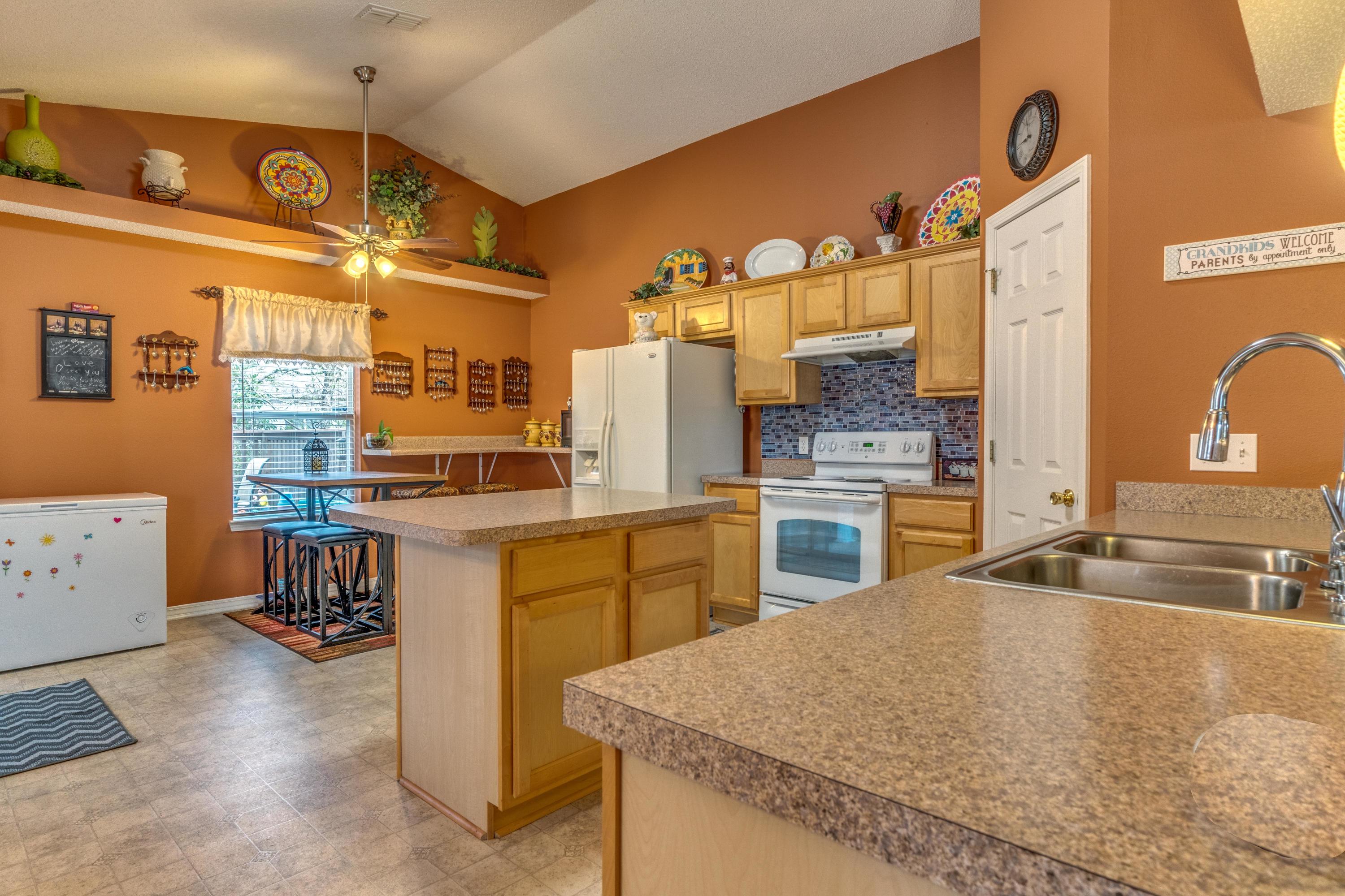272 Limestone Circle Crestview, FL 32539 - Photo 11 of 30 a kitchen with a refrigerator and a stove top oven