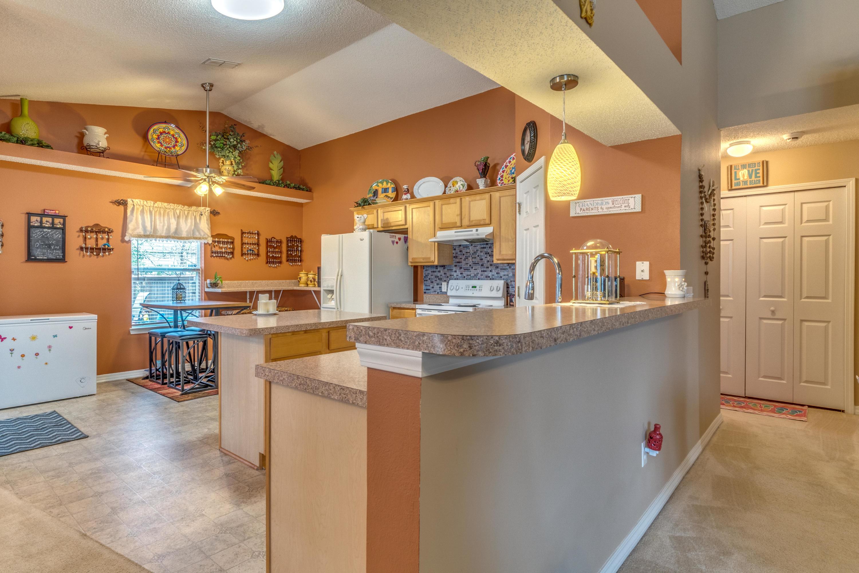 272 Limestone Circle Crestview, FL 32539 - Photo 12 of 30 a kitchen with stainless steel appliances kitchen island granite countertop a table and chairs in it