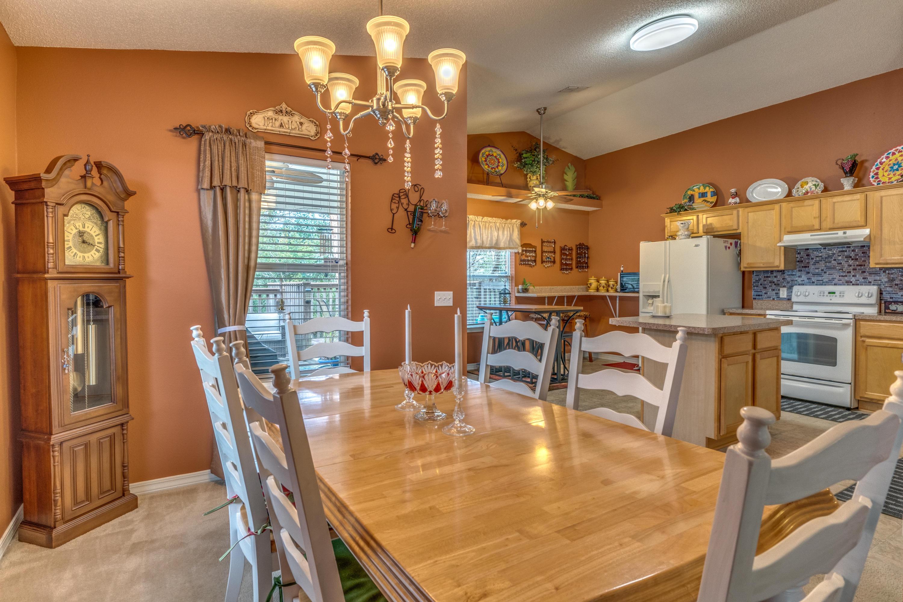 272 Limestone Circle Crestview, FL 32539 - Photo 13 of 30 a dining room with furniture a chandelier and wooden floor