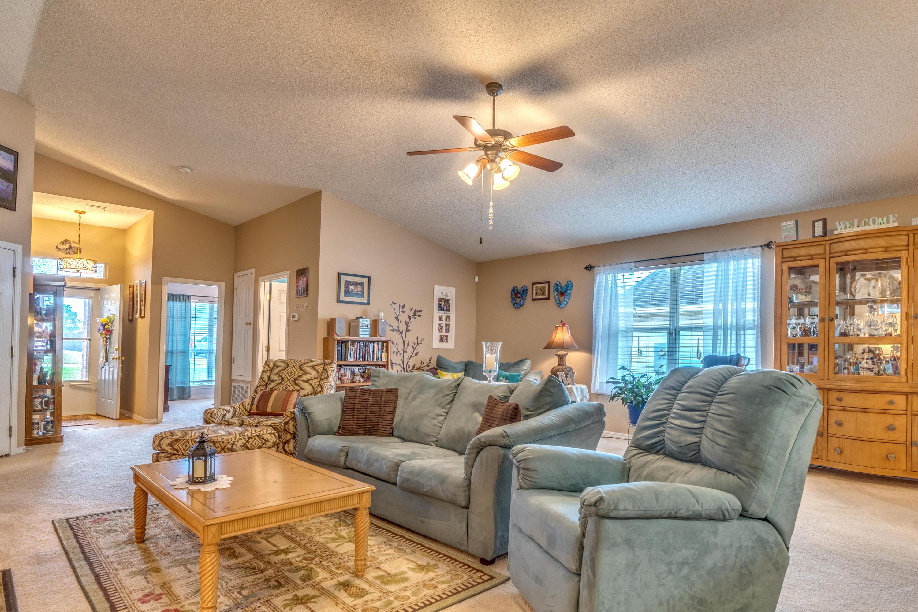 272 Limestone Circle Crestview, FL 32539 - Photo 15 of 30 a living room with furniture a large window and a chandelier