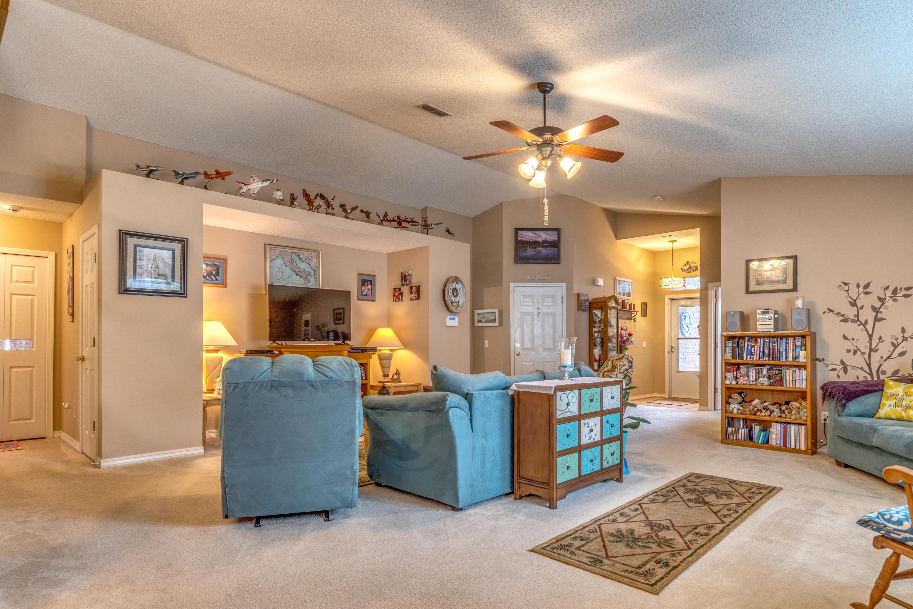 272 Limestone Circle Crestview, FL 32539 - Photo 16 of 30 a living room with lots of furniture and chandelier