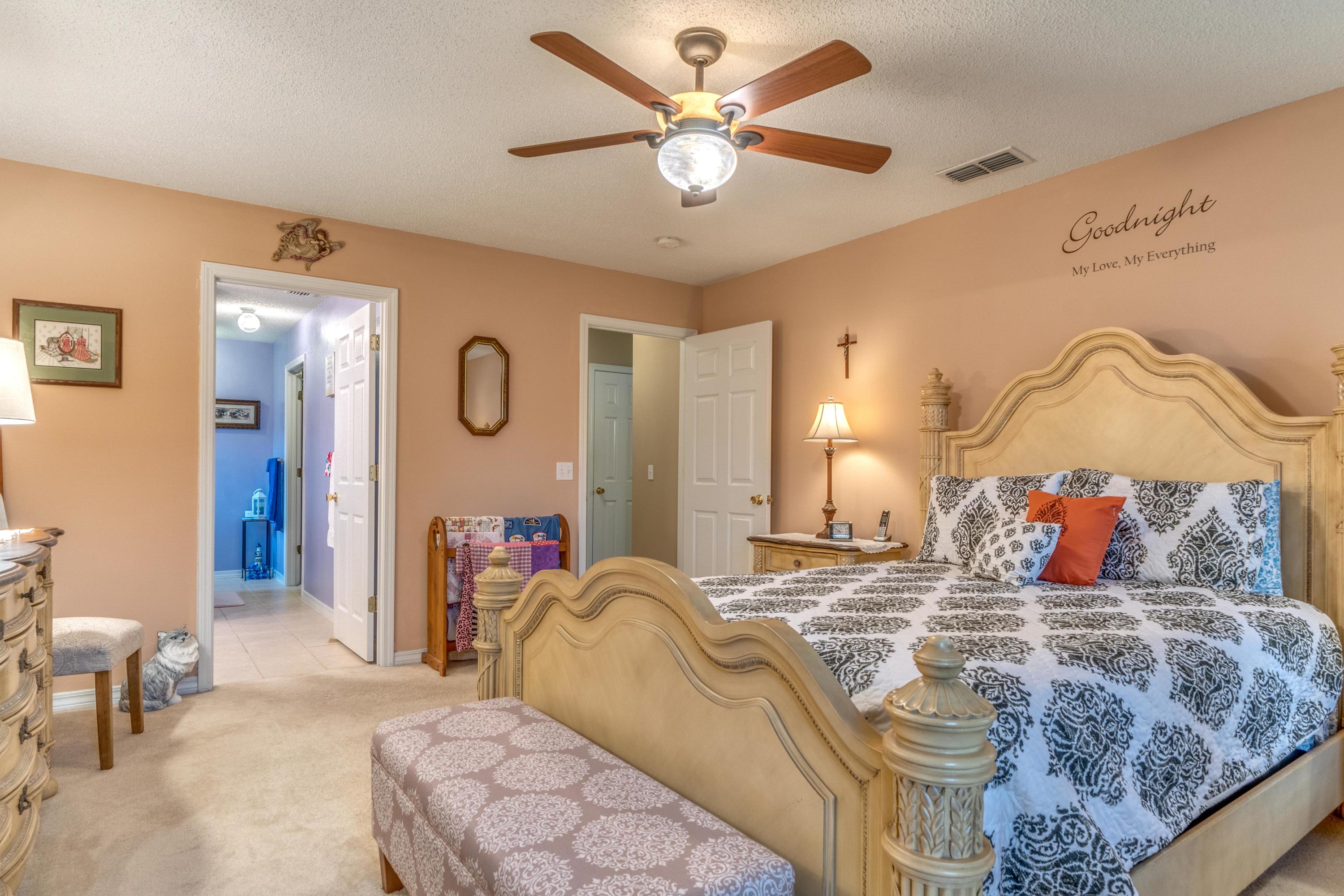 272 Limestone Circle Crestview, FL 32539 - Photo 23 of 30 a bed room with a bed and a chair