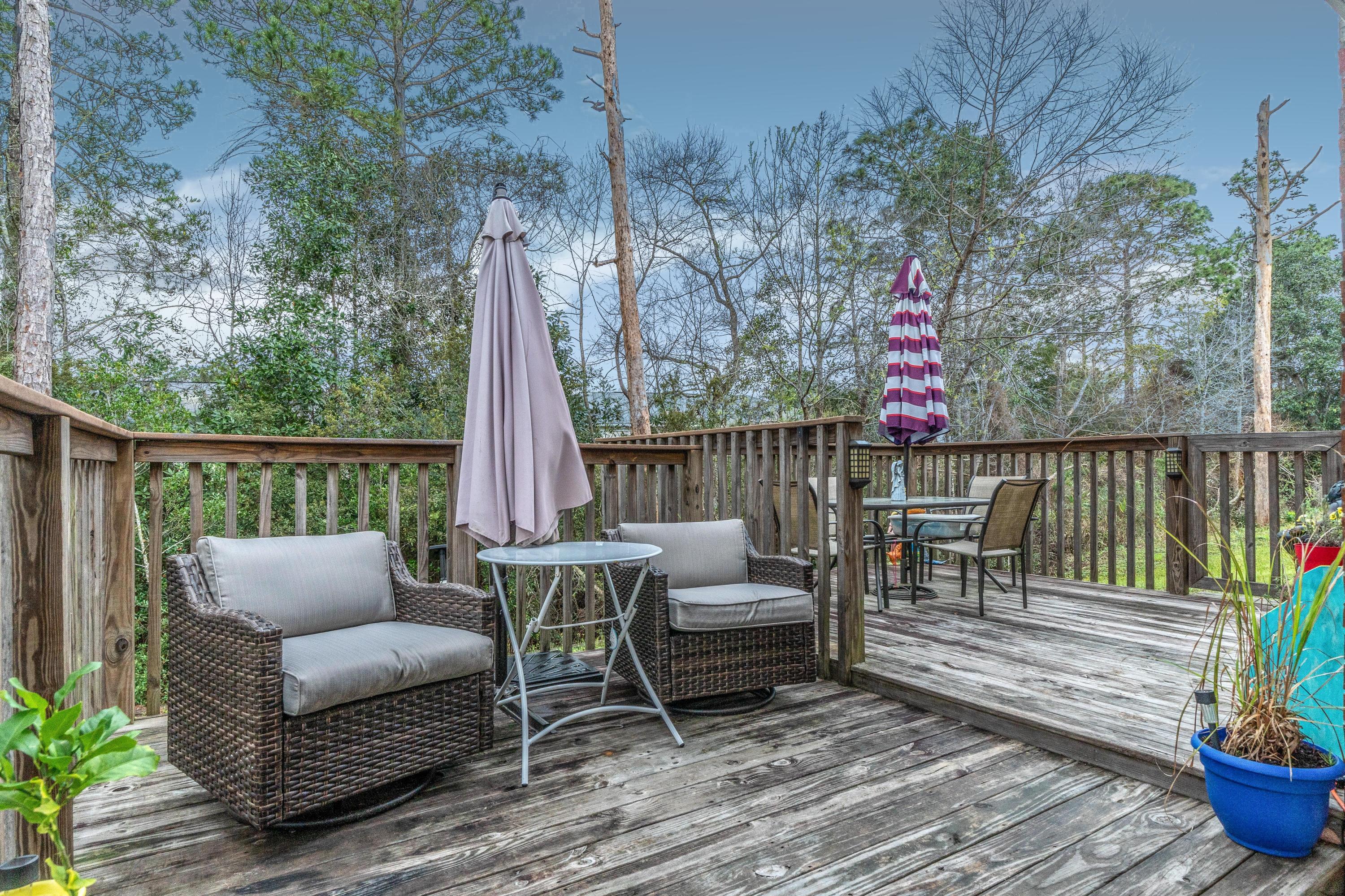 272 Limestone Circle Crestview, FL 32539 - Photo 3 of 30 a roof deck with table and chairs potted plants with wooden floor