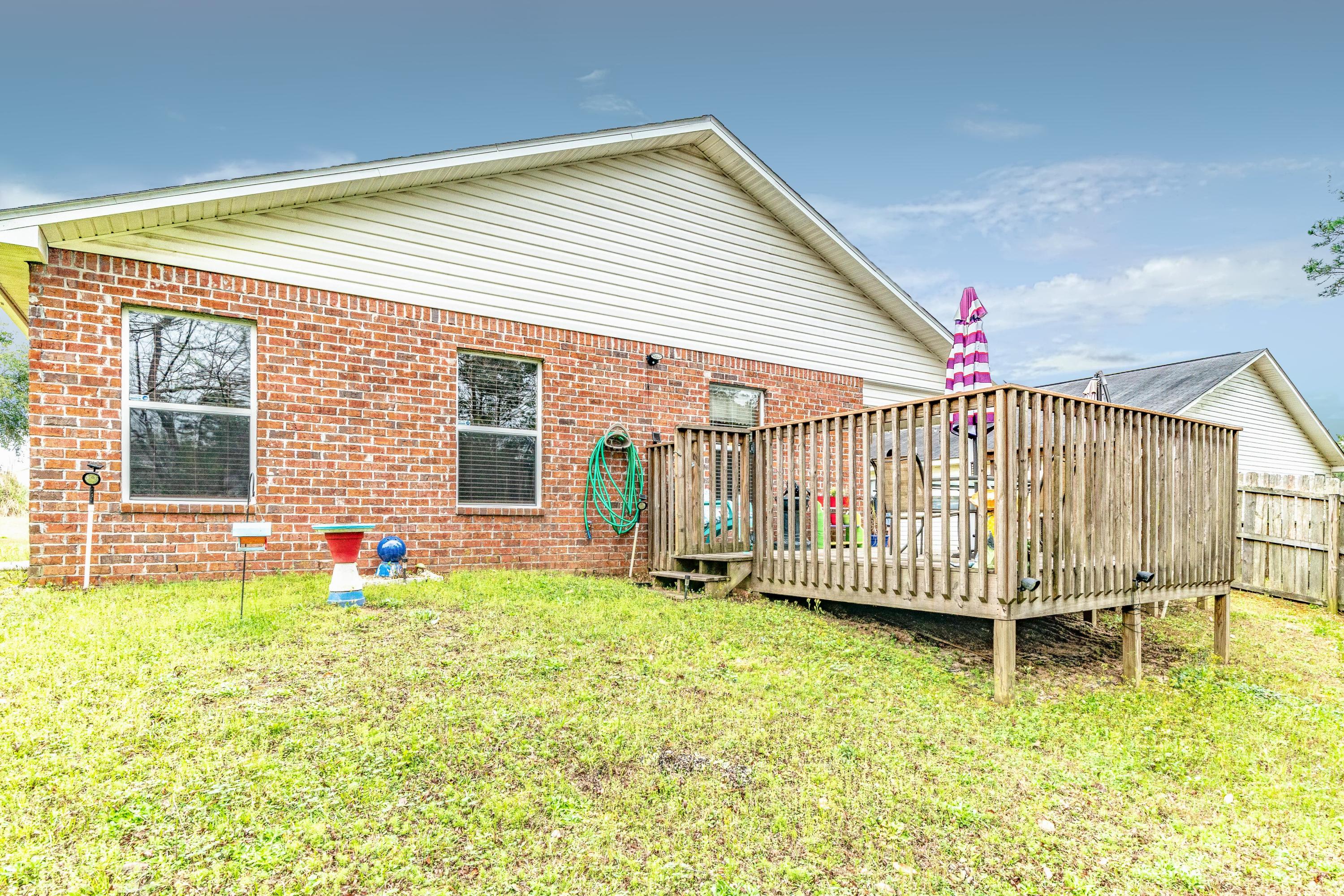 272 Limestone Circle Crestview, FL 32539 - Photo 6 of 30 a view of a house with a backyard and deck
