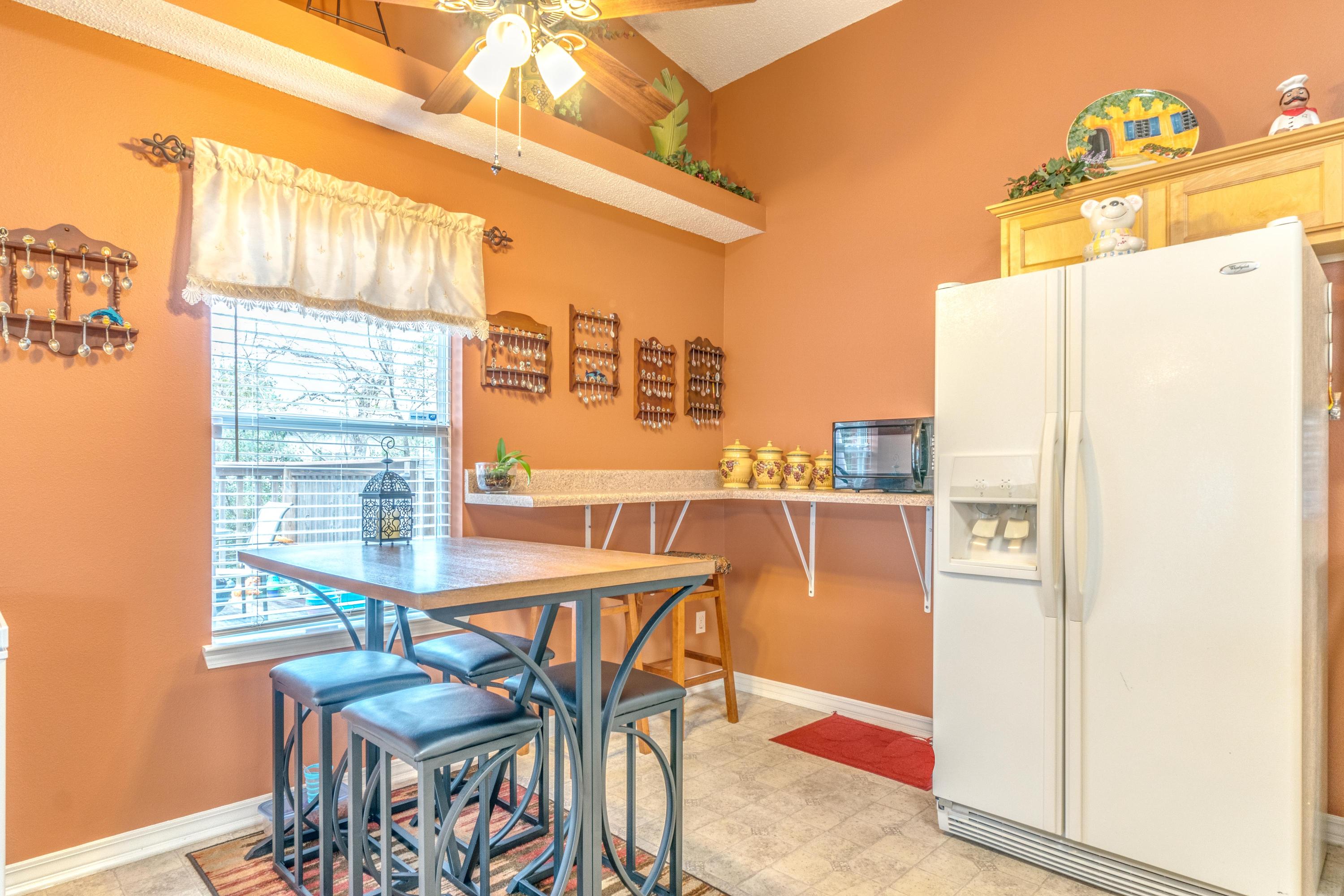 272 Limestone Circle Crestview, FL 32539 - Photo 8 of 30 a kitchen with a refrigerator a stove and a dining table with wooden floor