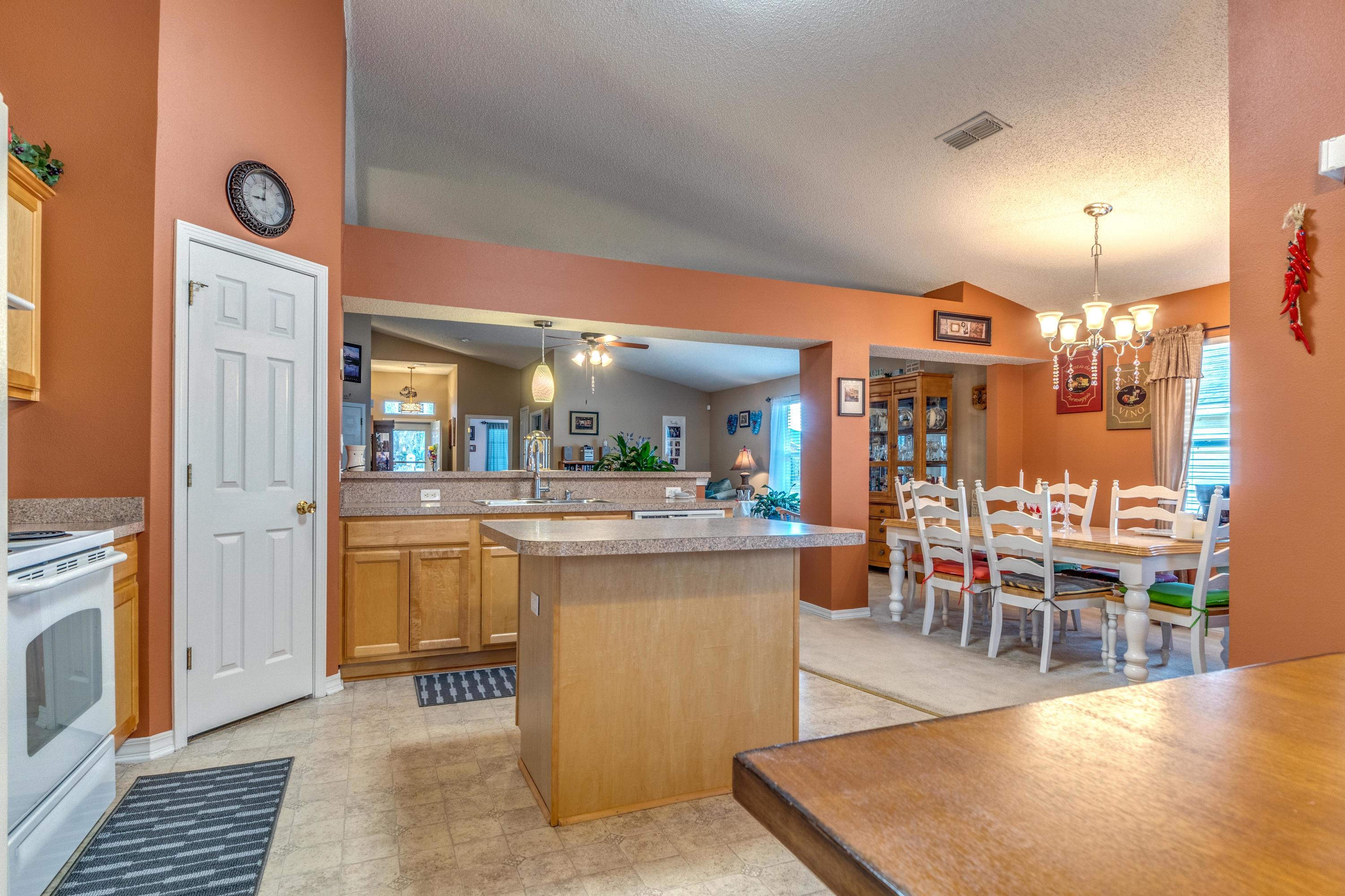 272 Limestone Circle Crestview, FL 32539 - Photo 10 of 30 a view of a kitchen with kitchen island dining table and wooden floor