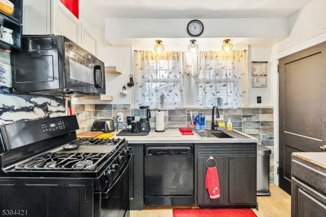 a kitchen with stainless steel appliances granite countertop a stove and a refrigerator