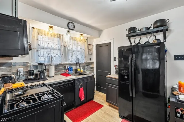 a kitchen with stainless steel appliances a stove a refrigerator and a sink