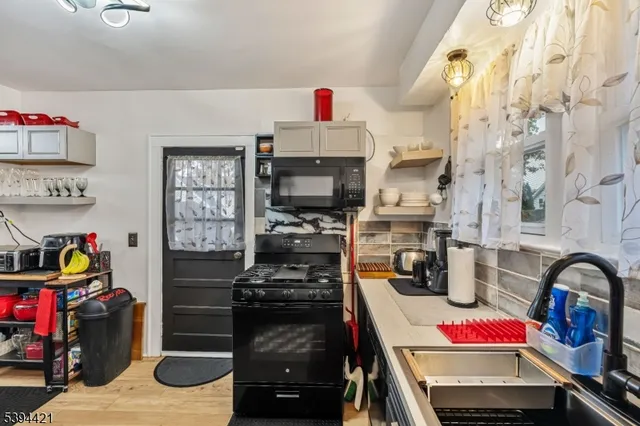 a kitchen with storage and utility