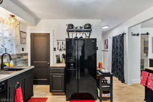 a kitchen with stainless steel appliances granite countertop a refrigerator and a stove