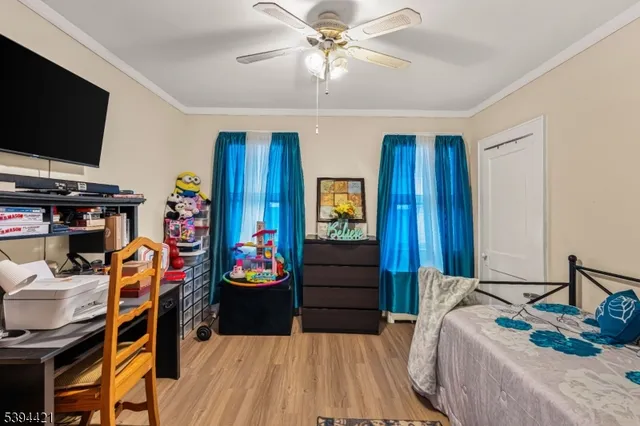 a bedroom with furniture and a flat screen tv